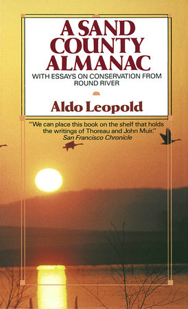Cover of A Sand Count Almanac showing the sun setting over a lake with a pair of geese flying across the sky. 